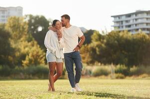 Front view... Lovely couple are having a walk on the field photo