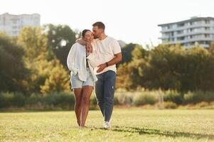 Front ,view. Lovely couple ,are having a walk on the field photo