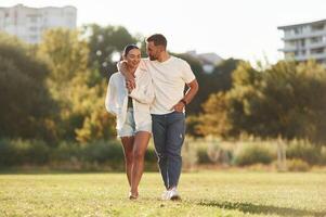 Front, view. Lovely couple are having a walk on the field photo