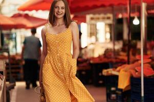 Cheerful, feeling happy., Young woman is on the vegetable market or bazaar photo