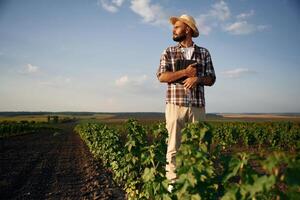 View from the front of him.. Farmer is on the agricultural field photo
