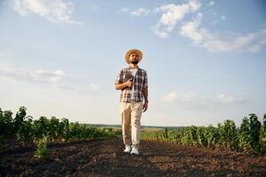 Front, view, ,,walking forward. Farmer, is on the agricultural field photo