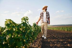 View,, from the front of him. Farmer is on the agricultural field photo