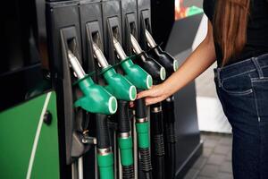 Focused detailed close up view. Young ,,woman on the gas station photo