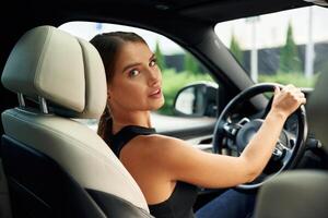 Looking, back.. Woman is sitting in the car photo