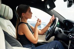 Side, view, talking ,by ,phone. Woman is sitting in the car photo