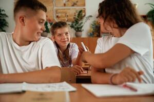 Taking the cheat sheet. Pupils, kids in the classroom together photo