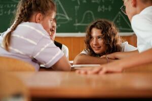Having ,fun on ,a, break time. Pupils, kids in the classroom together photo