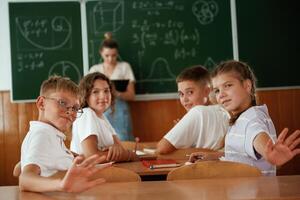Teacher,, is at work. Pupils, kids in the classroom together photo