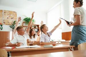 Teacher, is at work. Pupils, kids in the classroom together photo