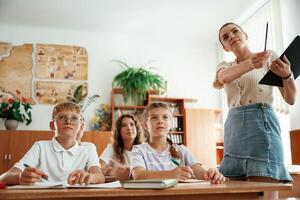 Teacher ,is at work. Pupils, kids in the classroom together photo