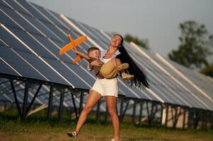 Mother with her little son are nea,r the ,solar ,panels photo