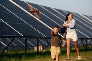 Mother with her little son are near the solar, panels photo
