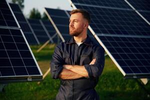 Handsome guy portrait. ..,Man is working with solar panels outdoors at daytime photo