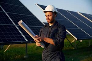 Man ,is, working, with solar panels outdoors at daytime photo