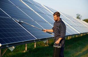 Man, is working with, solar panels outdoors at daytime photo