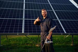 Keep,,, it clean. Man is working with solar panels outdoors at daytime photo