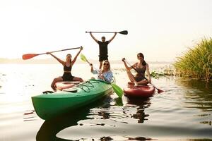 Women and man... Friends are together on sup boards on the lake photo
