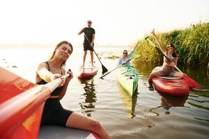 Taking ,selfie. .Friends are together on sup boards on the lake photo