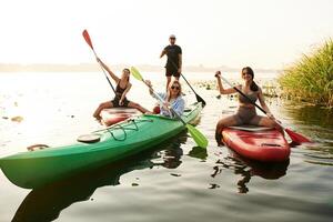 Wome,n and ,man. Friends are together on sup boards on the lake photo