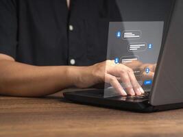 Man typing on a keyboard laptop with live chat chatting on application communication digital media websites and social network photo
