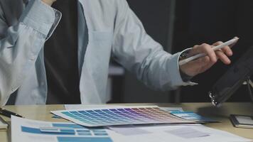 A man is using a tablet to look at color swatches video