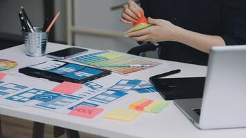 A person is working on a laptop and a desk with a lot of paper and stickers video