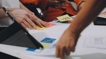 People working on a table with sticky notes video