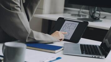 A person is using a tablet to draw on a paper video