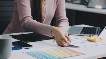 A woman is working on a project with a color palette video