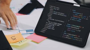 A person working on a laptop with a programming code on it video