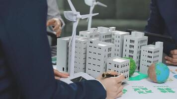 Business people working on a model of a city video