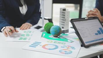 Business people working on a laptop and paper with graphs video