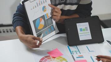 A man is holding a tablet with a chart on it video