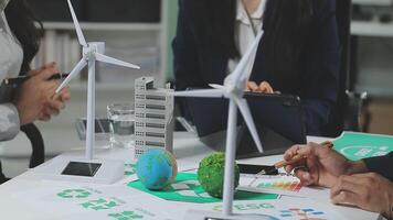 A group of people sitting around a table with wind turbines video