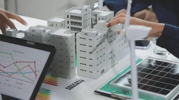 Business people working on a project with a laptop and paper models video