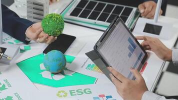 People working on a laptop with a green egg and other items video