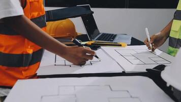 Two people working on a blueprint at a construction site video