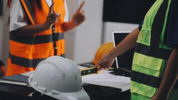A group of construction workers standing around a table video