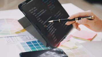 A person using a tablet to write on a white board video