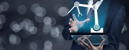 A man in a suit holding a tablet with a robot on it photo