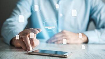 Man using smartphone with icons on screen photo