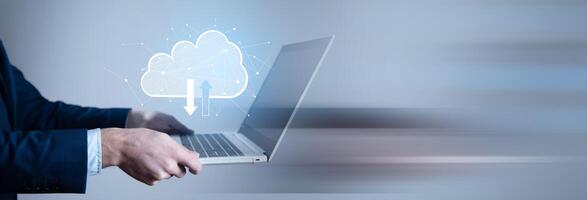 Man in suit holding laptop with cloud computing icon photo