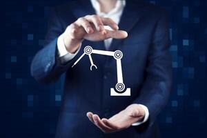 A man in a suit is holding a robot hand photo