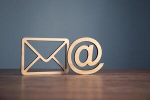 Email and email symbol on wooden table photo