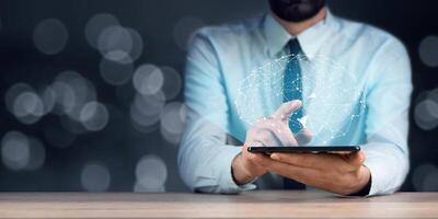 Man using tablet with network diagram photo