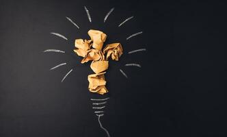 A light bulb with crumpled paper on it photo