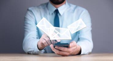 Man using email icon on his smartphone photo