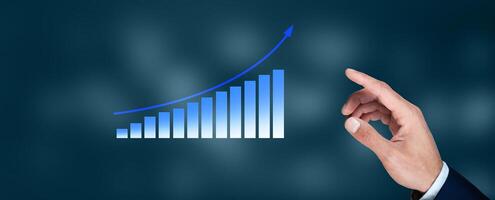 A hand pointing to a graph on a blue background photo