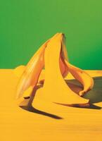 a banana on a table with a green background photo